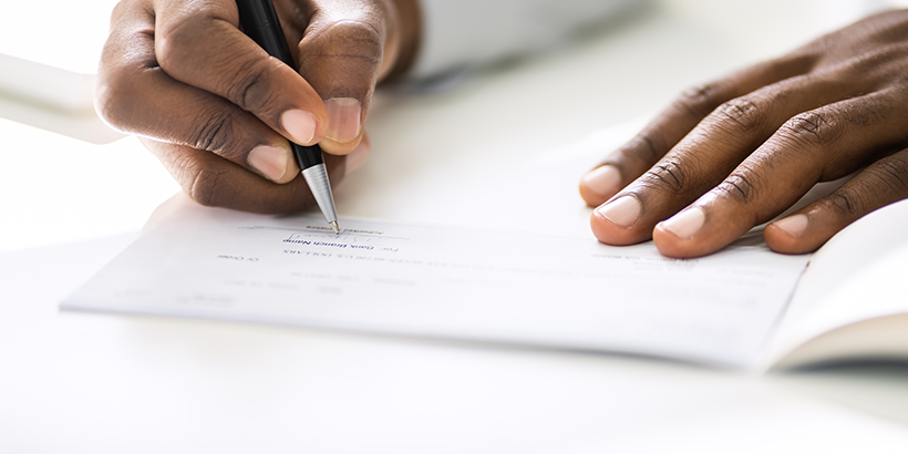 Hands signing document