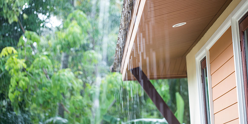 Rain falling from the roof of a single-family house