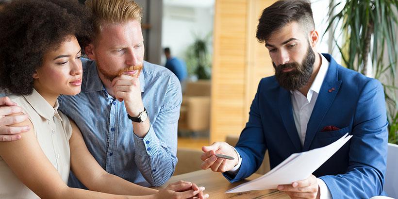 Homebuyers consulting with lender