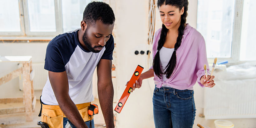 Man and woman looking at blueprints