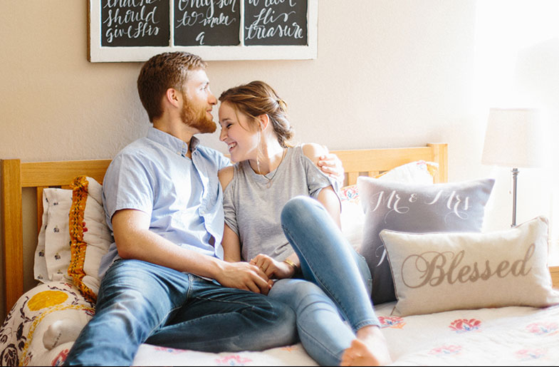 Image of couple sitting on the bed