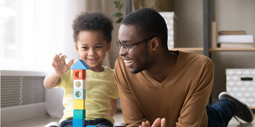 Father and son with building blocks