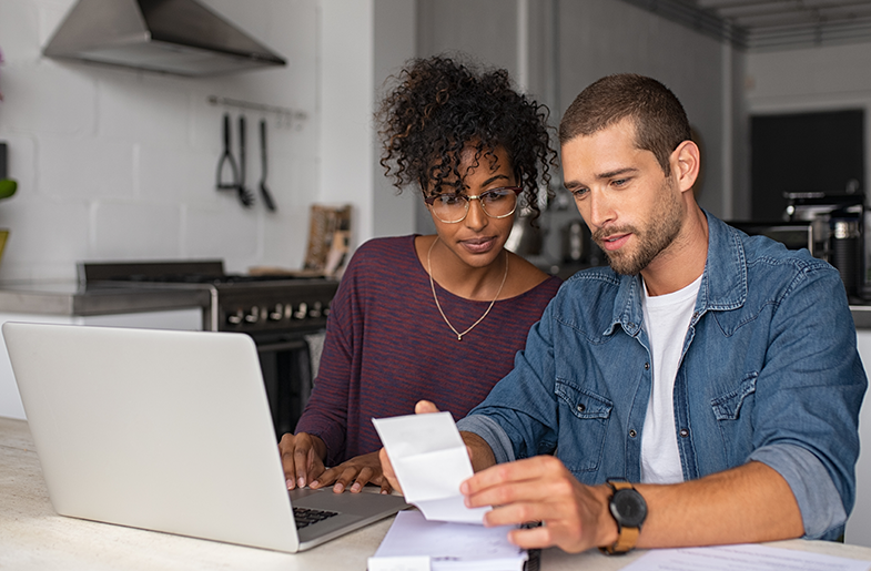 Couple sitting in front of laptop