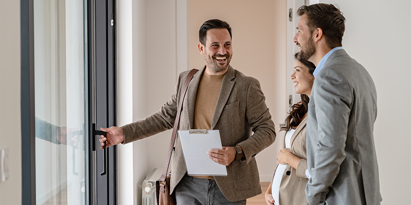Man opening door while talking to other people