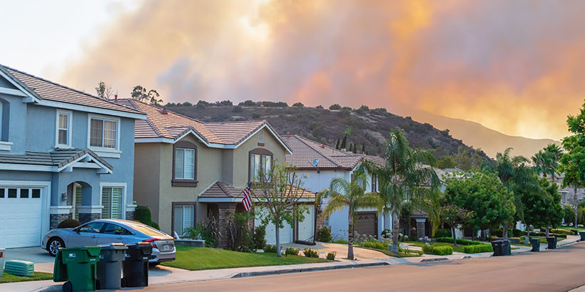 Neighborhood with smoke in the background