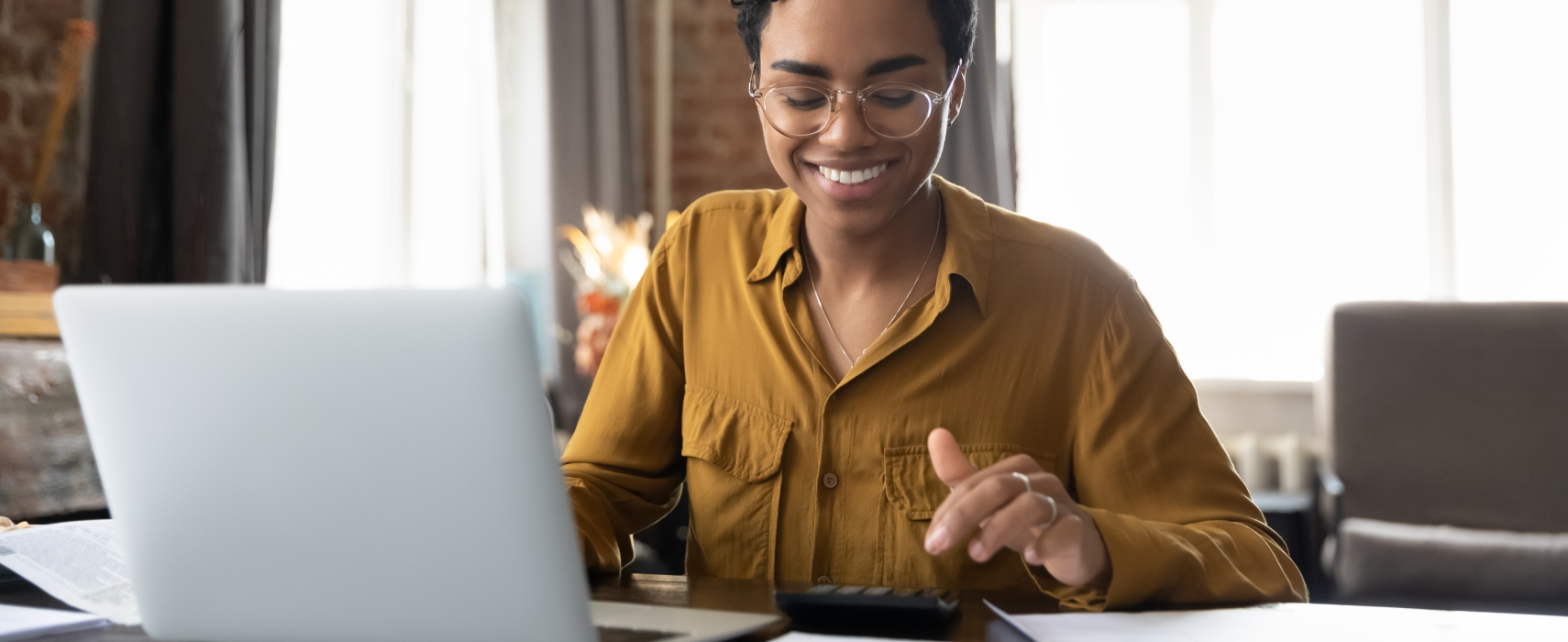 Woman on laptop and calculator