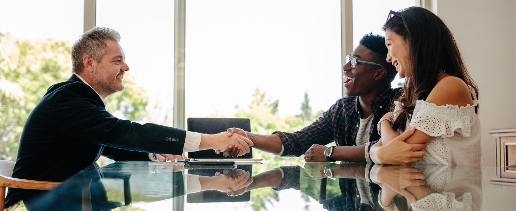 Two men and woman shaking hands