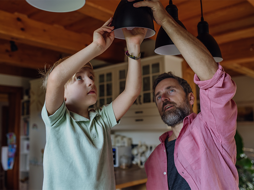 Father and child changing a lightbulb