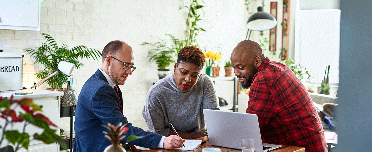 Homeowners talking to a mortgage professional about refinancing