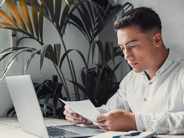 Future renter reviews documents in front of a computer