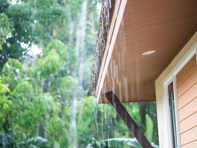 Rain falling from the roof of a single-family house