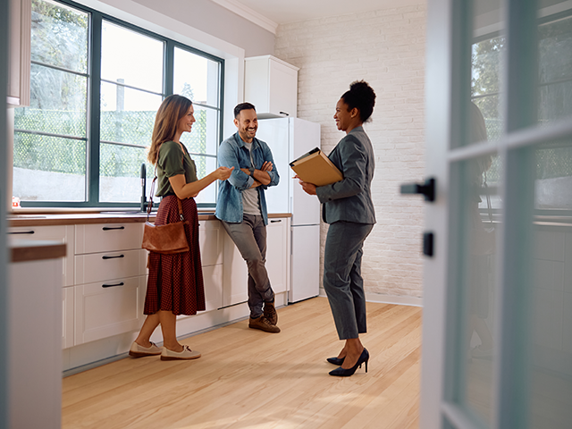 Homebuyers talking with a real estate agent