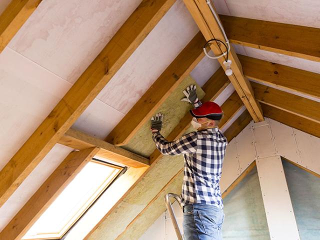 Homeowner installing insulation