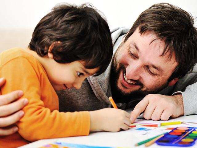 Man coloring with son