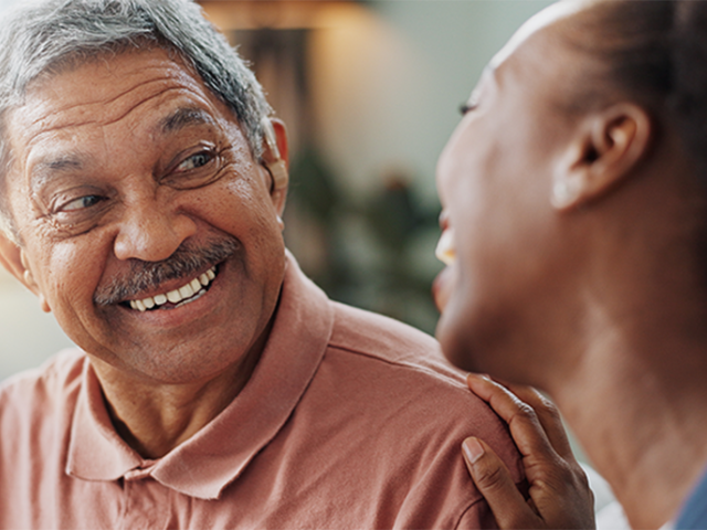 Two people laughing in living room