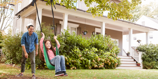 Girl on swing in front yard
