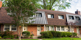 Brick townhomes surrounded by trees