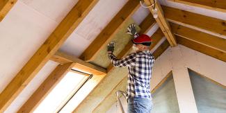 Homeowner installing insulation
