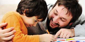 Man coloring with son