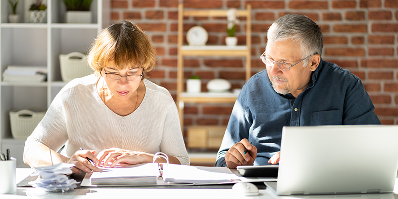 Couple reviewing finances at kitchen table