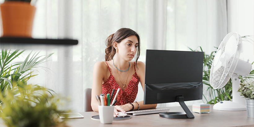 Person sitting at desk looking at a computer