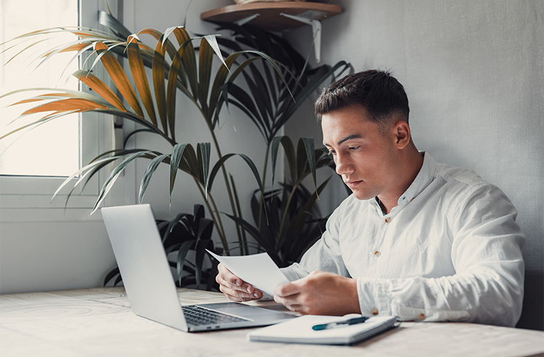 Future renter reviews documents in front of a computer