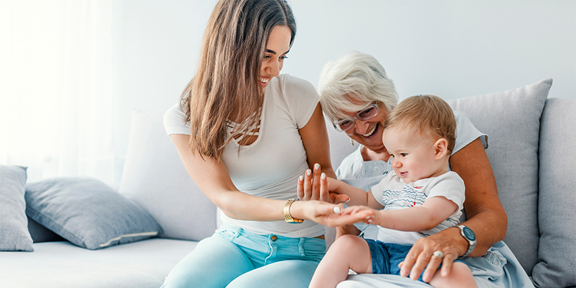 Adults sitting on couch with a child