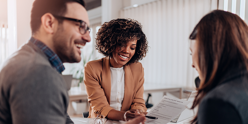 Woman reviewing contract with couple