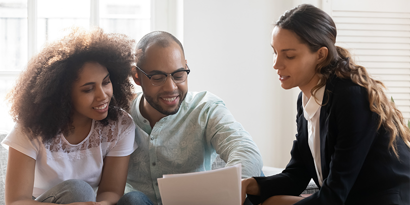 Couple reviewing their finances with an advisor