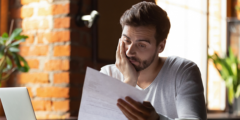Person reviewing paperwork carefully