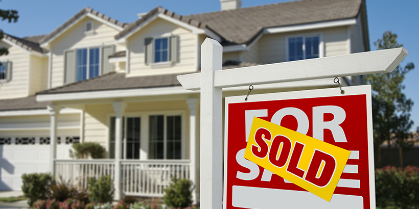 Home with a for sale sign in front