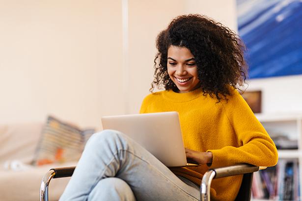 Person on couch looking at laptop