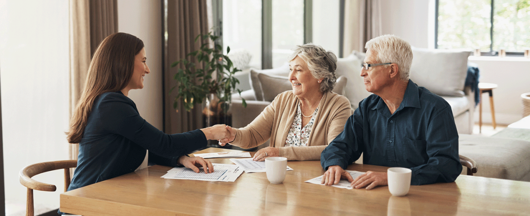 Older couple meeting with real estate professional