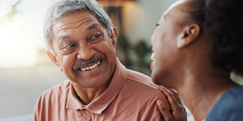 Two people laughing in living room