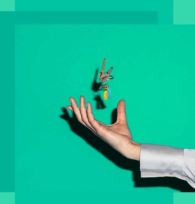 A person's hand tossing keys up