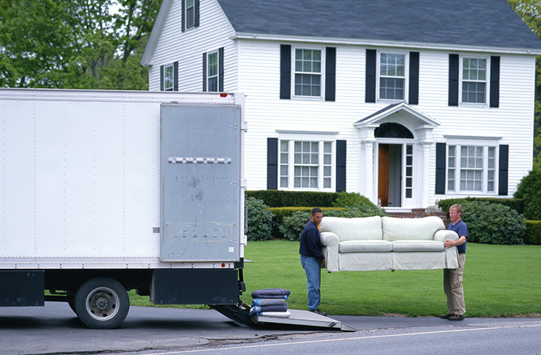 People loading furniture into a moving truck.