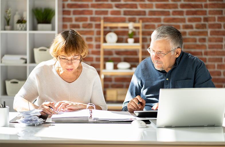 Couple reviewing finances at kitchen table