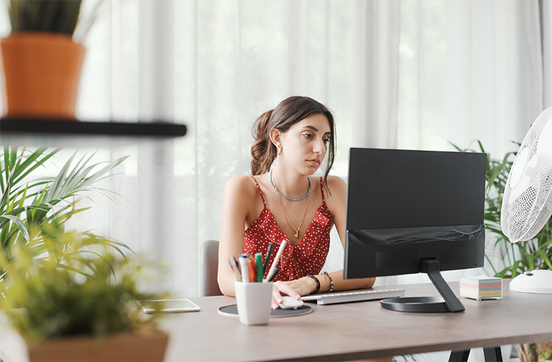 Person sitting at desk looking at a computer