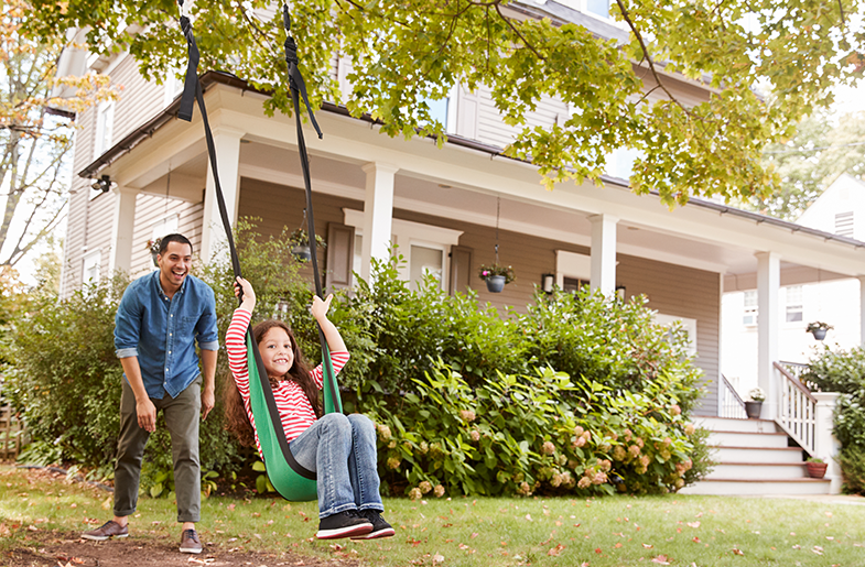 Girl on swing in front yard