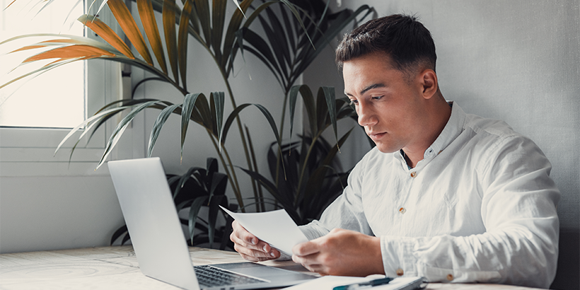 Future renter reviews documents in front of a computer