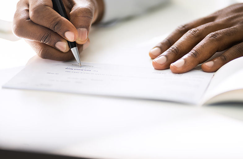 Hands signing document