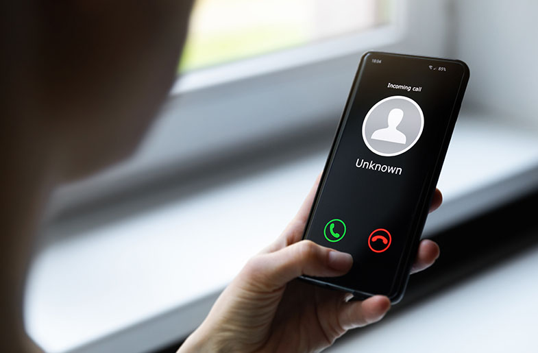 Person looking at phone to determine who the caller is