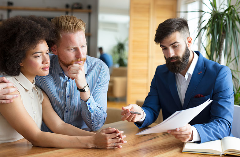 Homebuyers consulting with lender