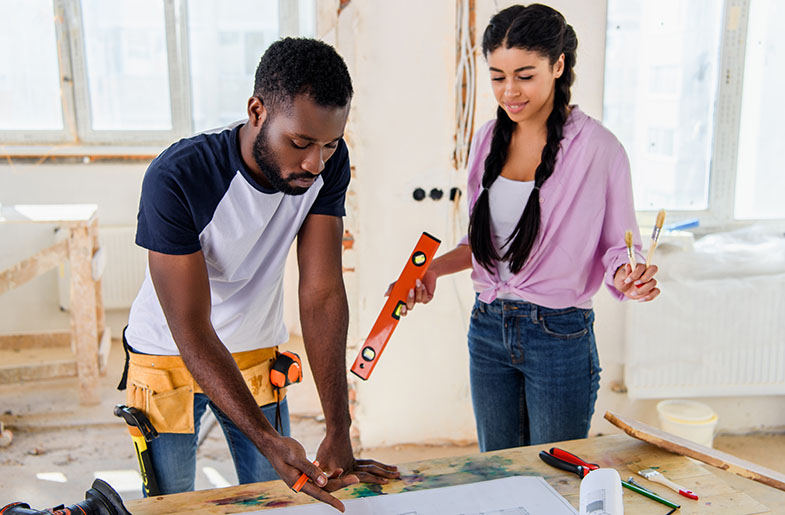 Man and woman looking at blueprints