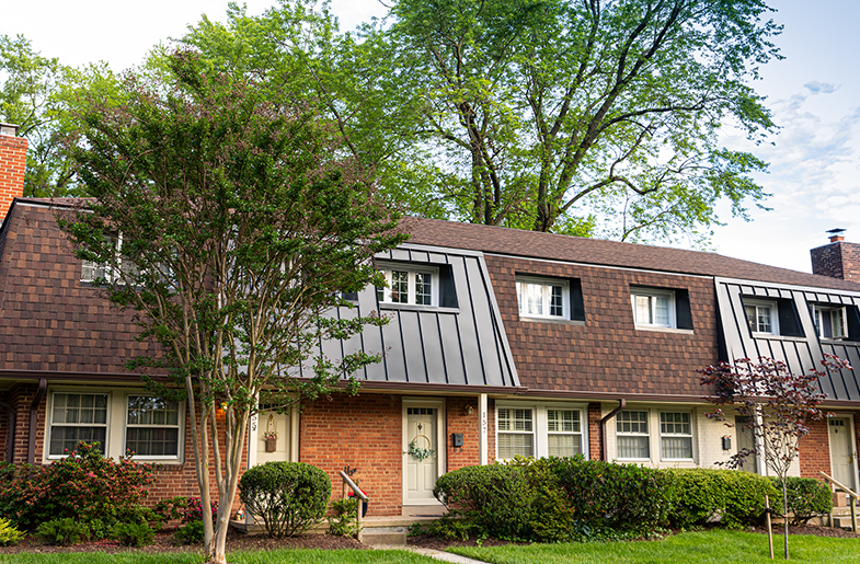 Brick townhomes surrounded by trees