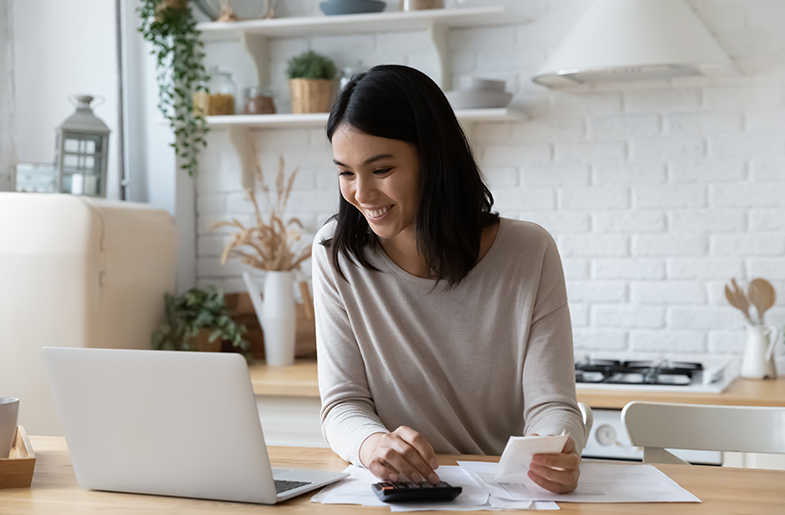 Person reviewing their finances at the kitchen counter