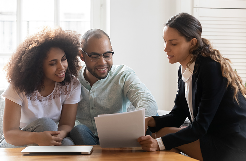 Couple reviewing their finances with an advisor