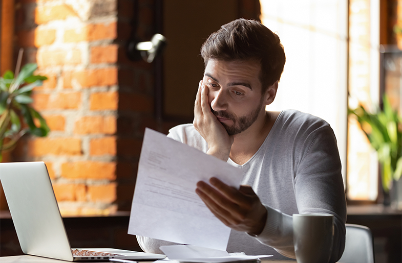 Person reviewing paperwork carefully