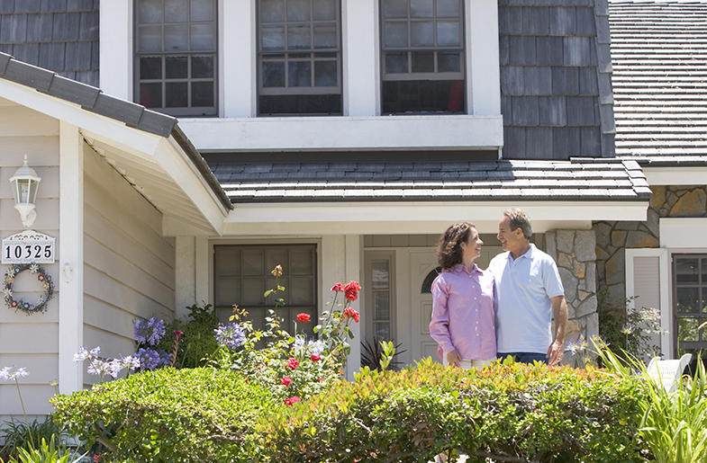 Couple standing in front of house