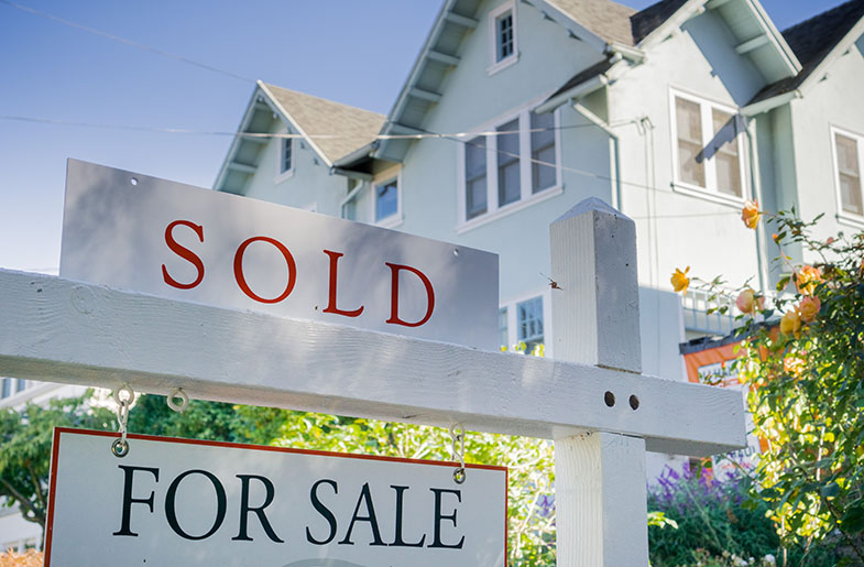 Sold sign in front of house